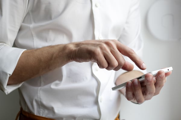 closeup man holding smartphone