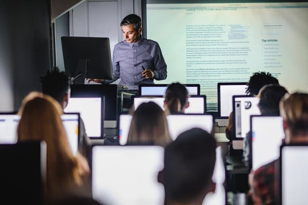 college professor teaching in computer lab